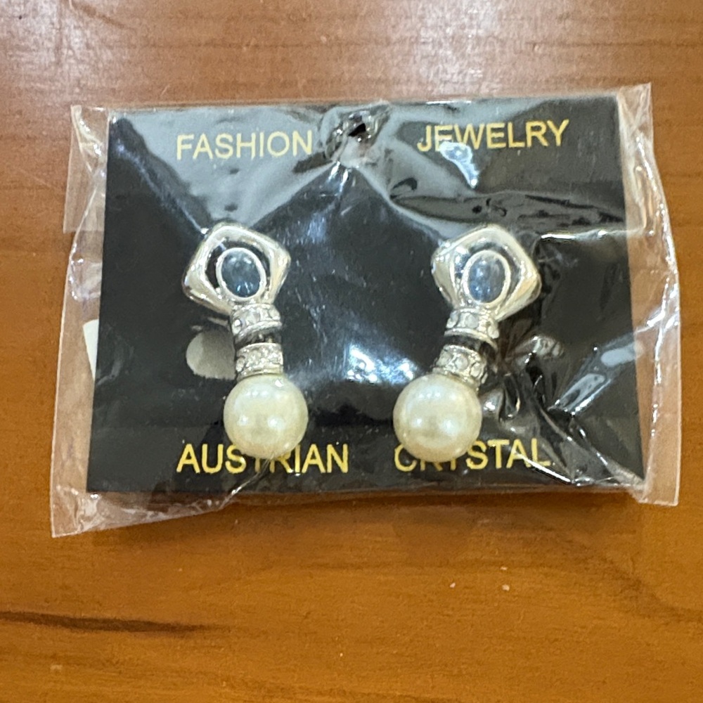 Elegant Silver and Pearl Earrings. Has white small stones and a big blue stone